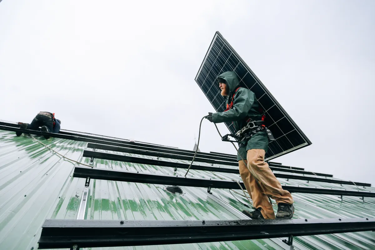 Operario ajustando un panel solar
